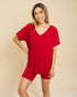Woman wearing a red outfit on a beige background