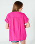 Woman wearing a bright pink blouse on a white background