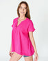 Woman wearing a bright pink blouse on a white background