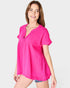 Woman wearing a bright pink blouse on a white background