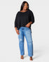 Woman wearing a black top and blue jeans on a white background