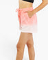 A person wearing pastel pink and white gradient drawstring shorts with side pockets, shown from the torso down against a plain white background.