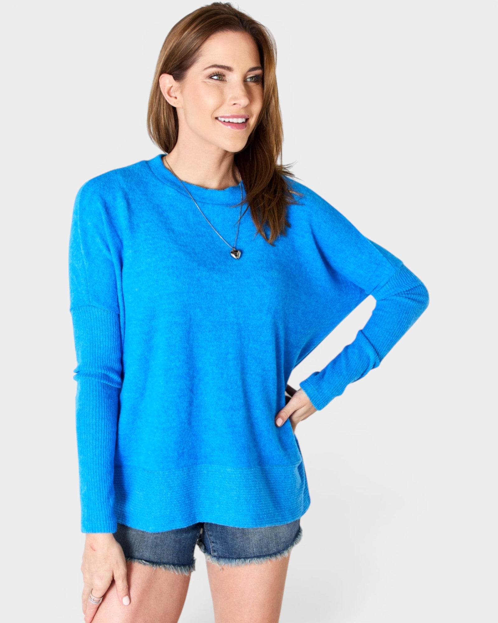 Woman wearing a blue sweater on a white background