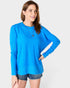 Woman wearing a blue sweater on a white background