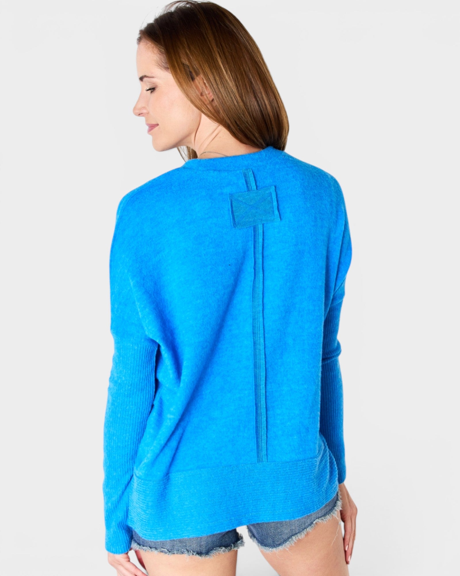 Woman wearing a blue sweater on a white background