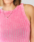 Close-up of a person wearing a pink tank top with a necklace.