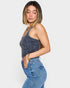 Woman wearing a denim tank top and jeans on a white background