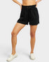 Person wearing black shorts on a white background