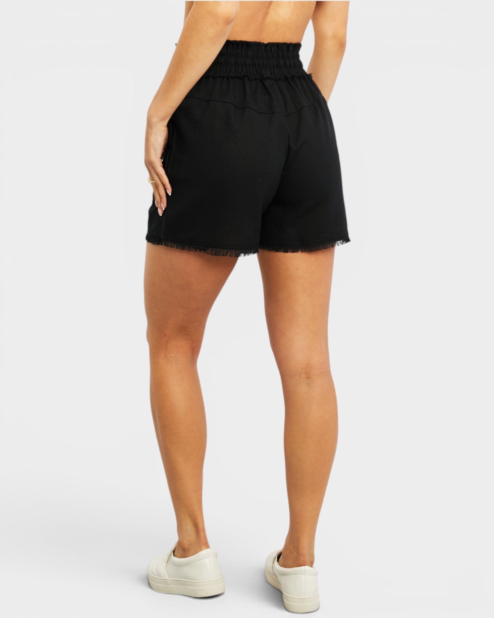 Black shorts worn by a person on a white background