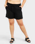 Person wearing black shorts on a white background