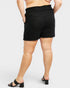 Person wearing black shorts on a white background