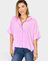 Woman wearing a pink blouse and blue jeans on a white background