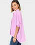Woman wearing a pink blouse with a white background