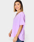 Woman wearing a light purple blouse with a plain background