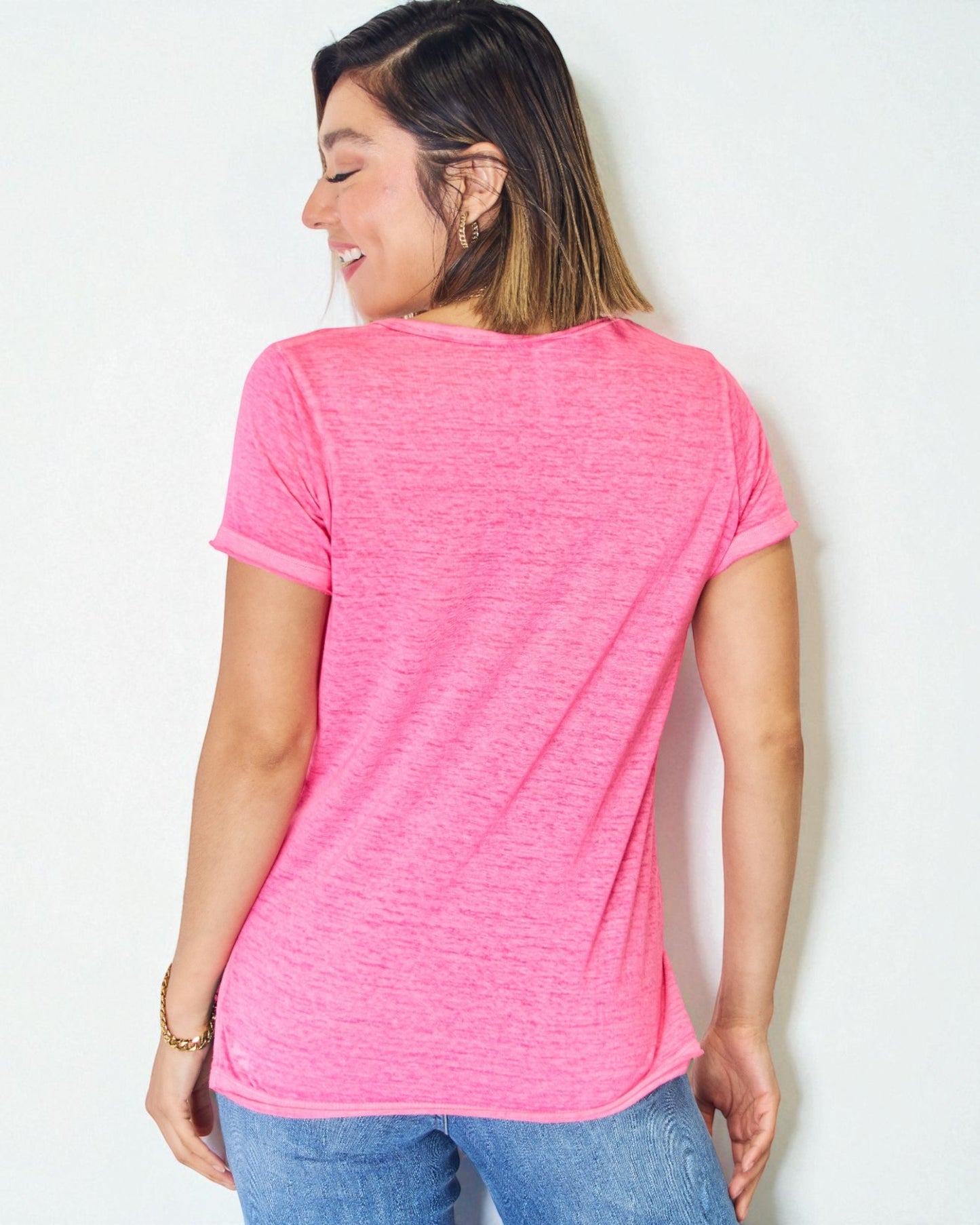 Woman wearing a pink t-shirt against a white background