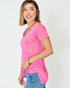 Woman wearing a pink top and blue jeans on a white background