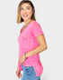 Woman wearing a pink top and blue jeans on a white background