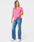 Woman wearing a pink top and blue jeans on a white background