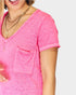 Person wearing a bright pink top with a pocket on a white background
