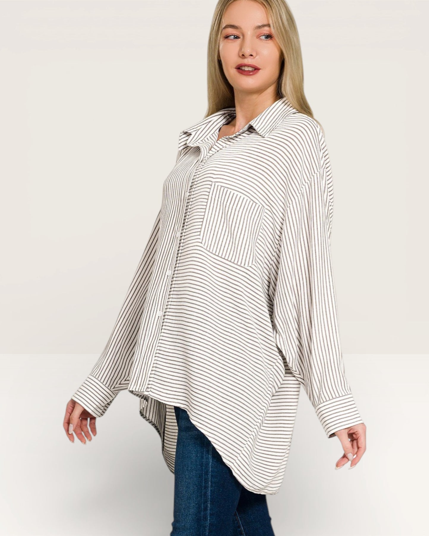 Woman wearing a striped shirt and jeans on a white background