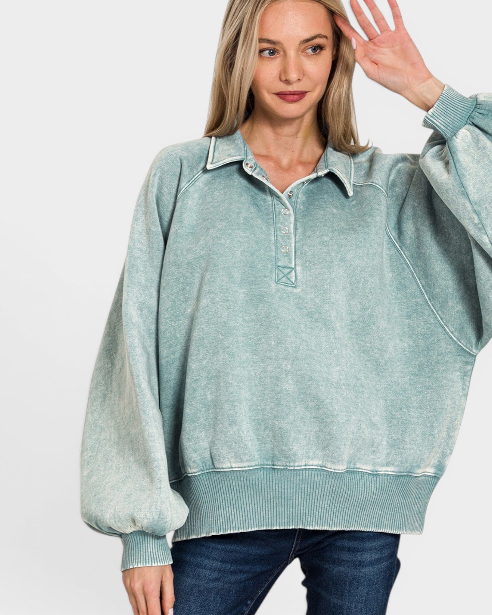 Woman wearing a light blue pullover with a white background