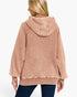 A woman shown from the back wearing a dusty rose hooded sweatshirt and dark blue jeans against a plain white studio background.