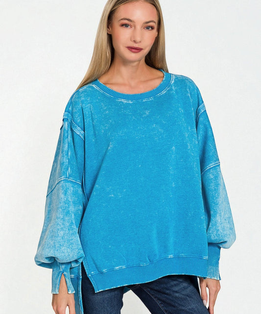 Woman wearing a blue distressed sweater on a white background