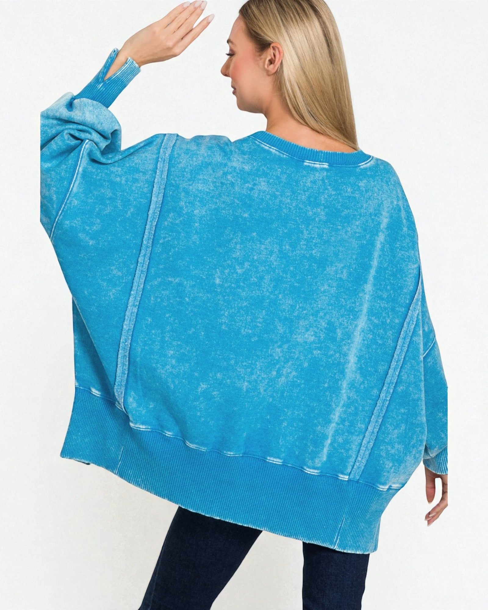 Woman wearing a blue oversized sweater on a white background