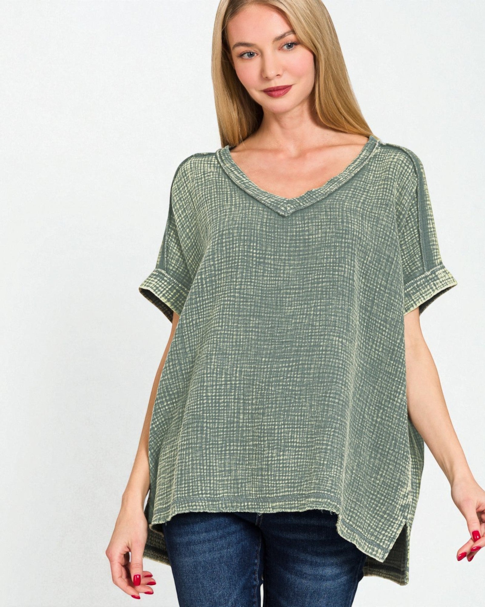 Woman wearing a green patterned top on a white background