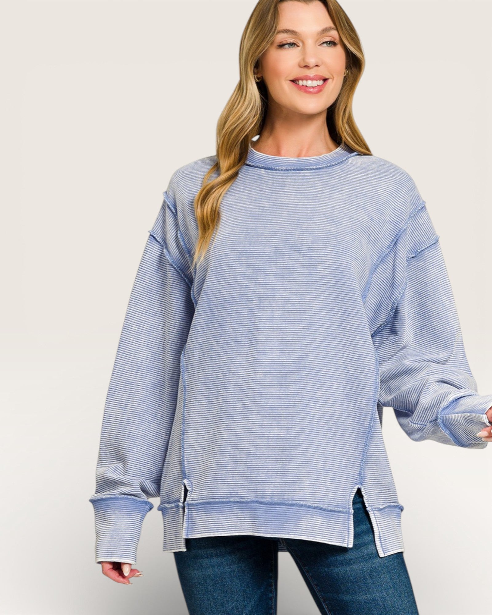 Woman wearing a blue striped sweater on a white background
