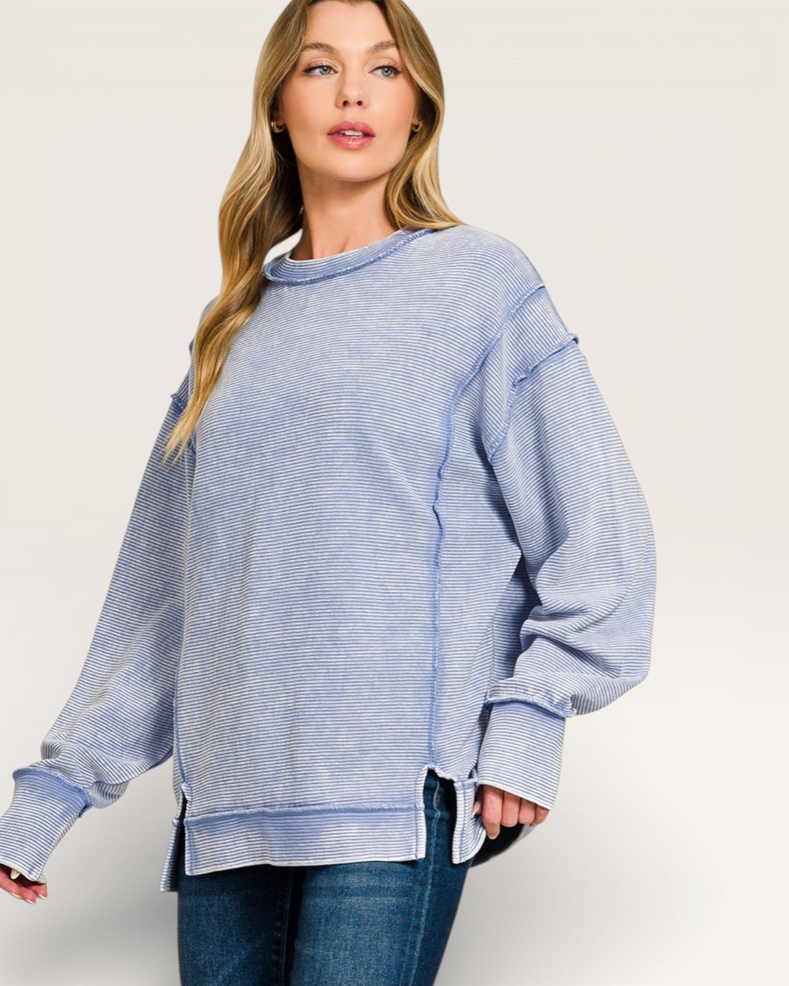 Woman wearing a blue striped sweater on a white background