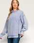 Woman wearing a blue striped sweater on a white background