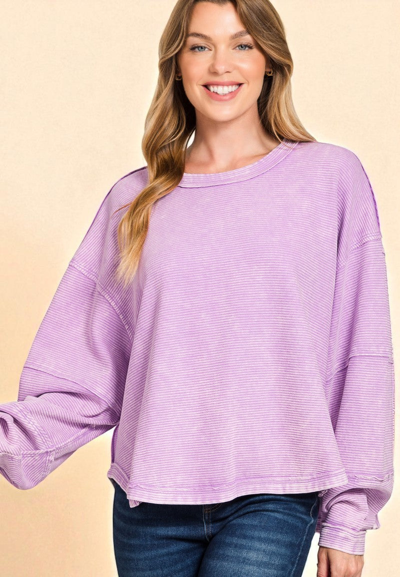 Woman wearing a purple sweater on a beige background