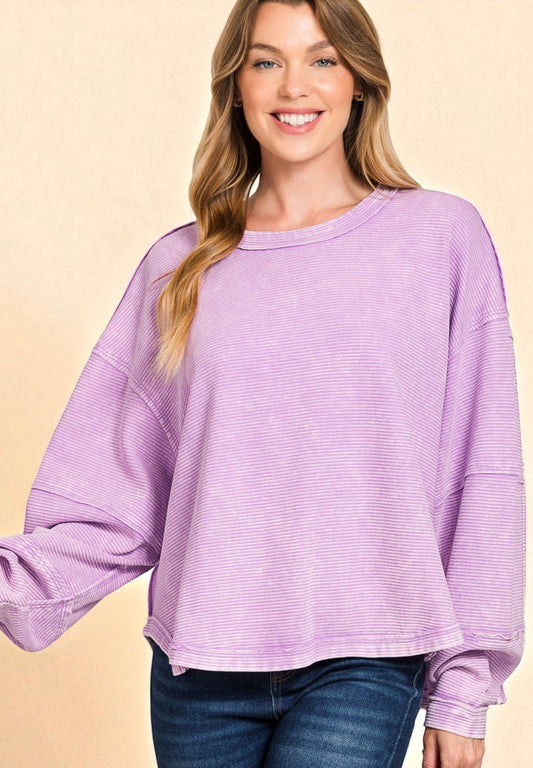 Woman wearing a purple sweater on a beige background