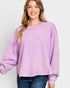 Woman wearing a purple sweatshirt against a white background
