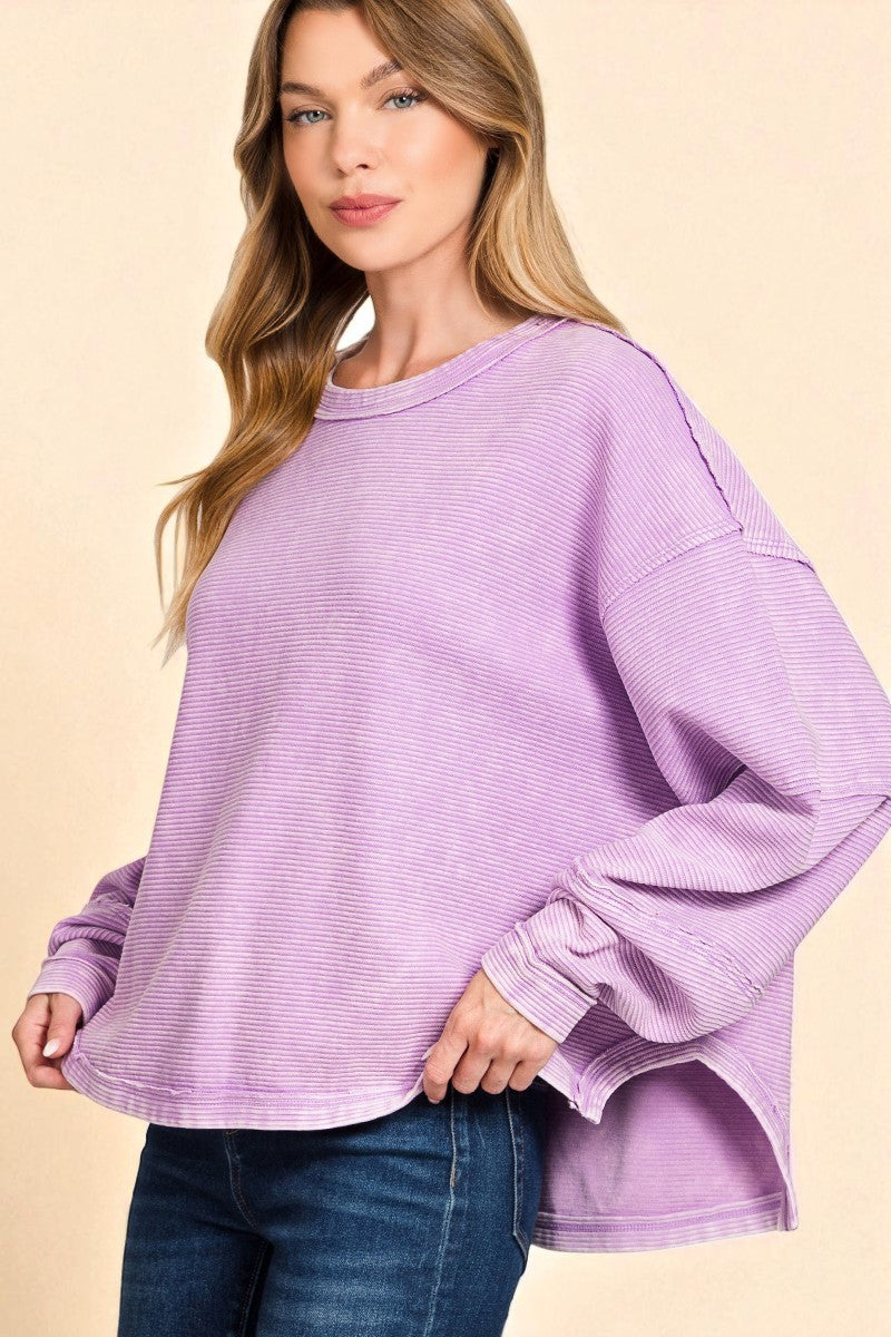 Woman wearing a purple sweater on a beige background