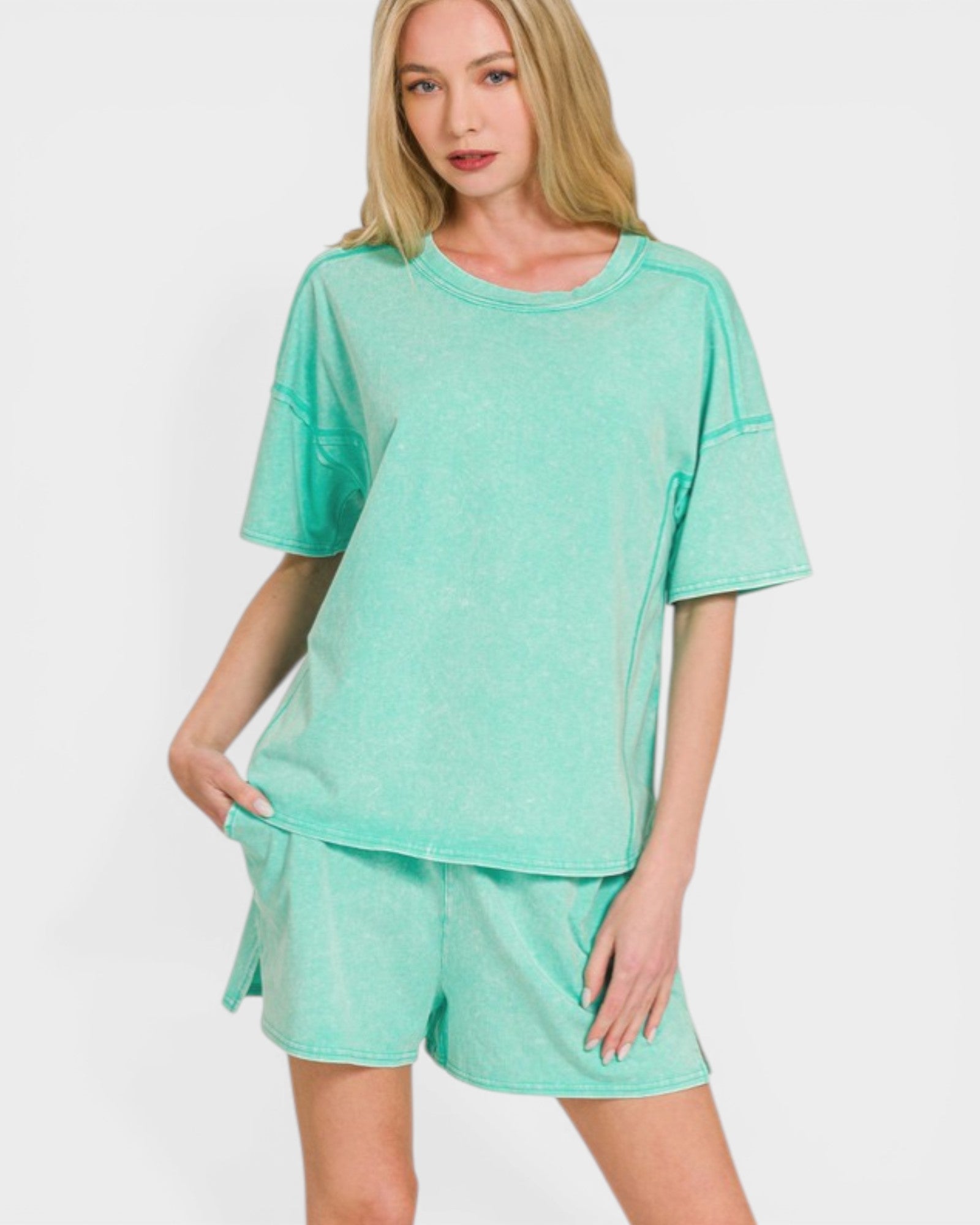Woman wearing a mint green outfit on a white background