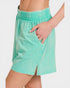 Teal shorts worn by a person on a white background