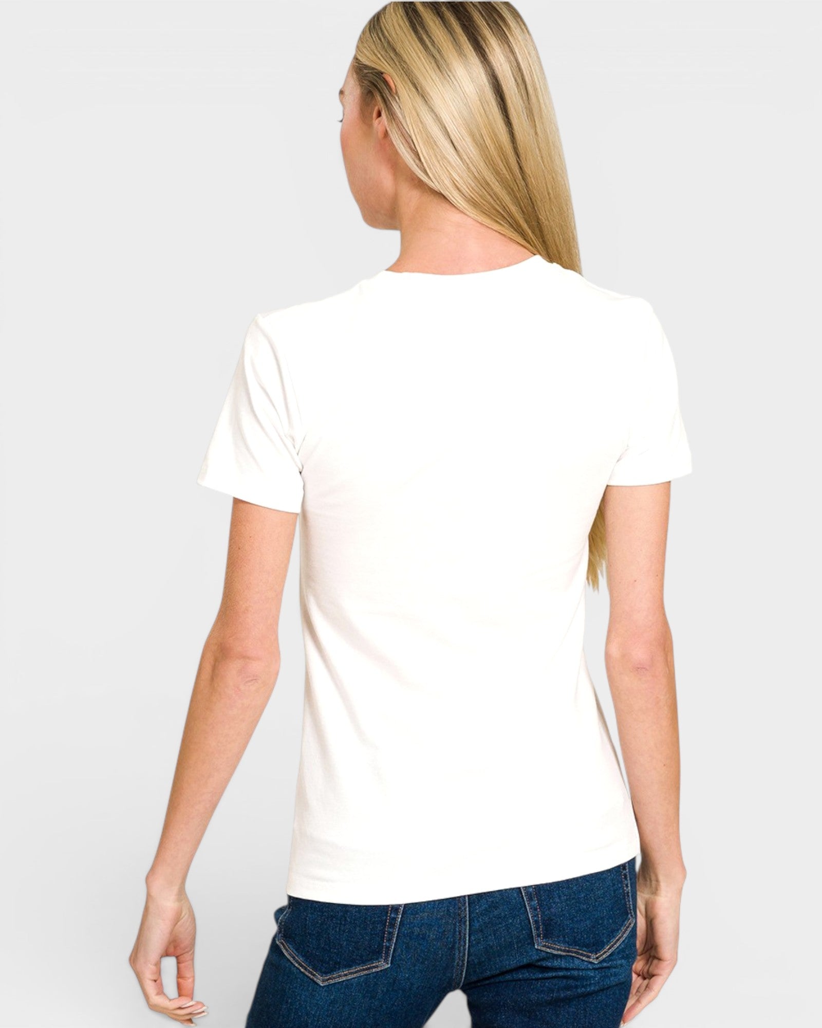 Person wearing a white t-shirt with a logo on the back against a plain background