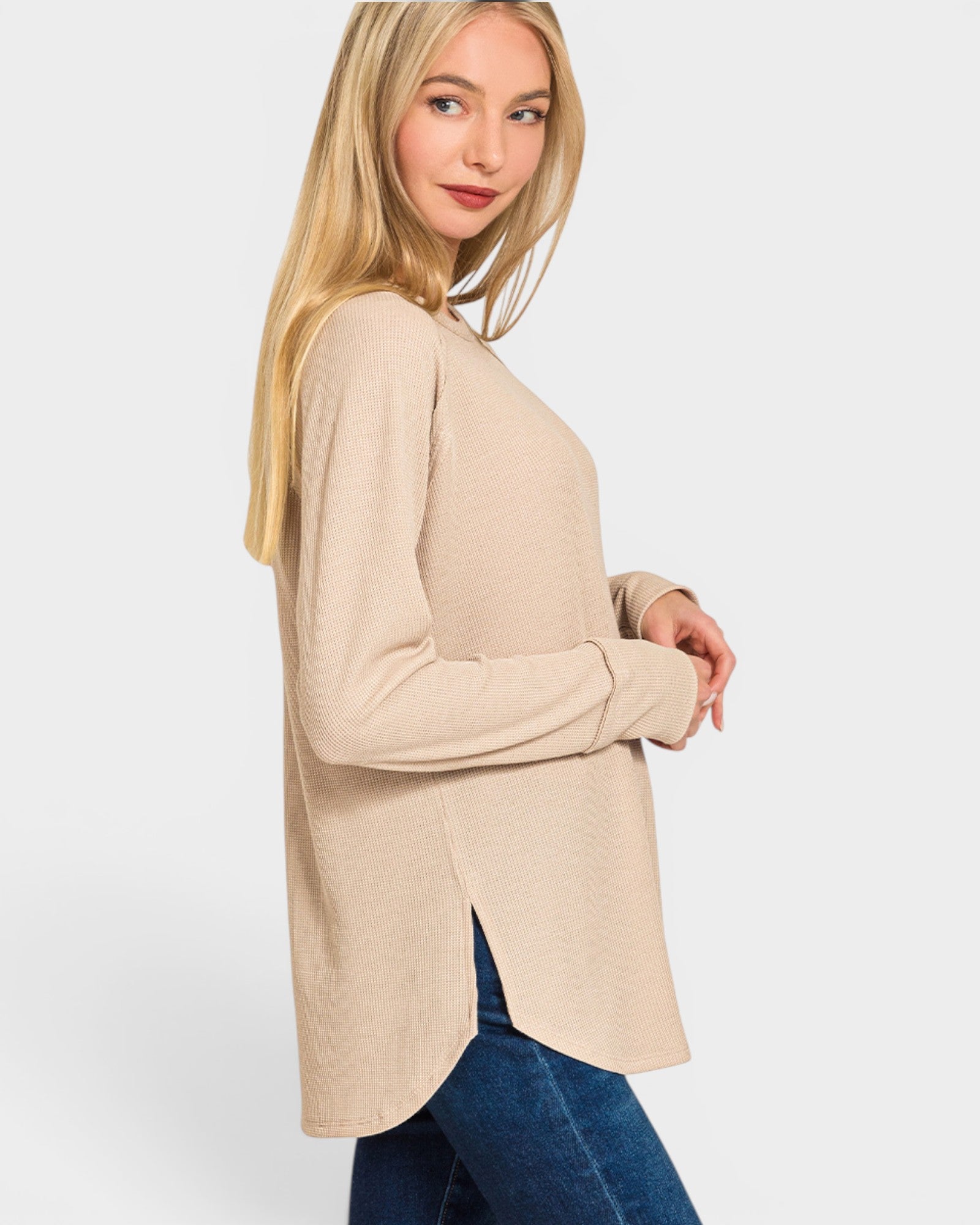 Woman wearing a beige cardigan on a white background