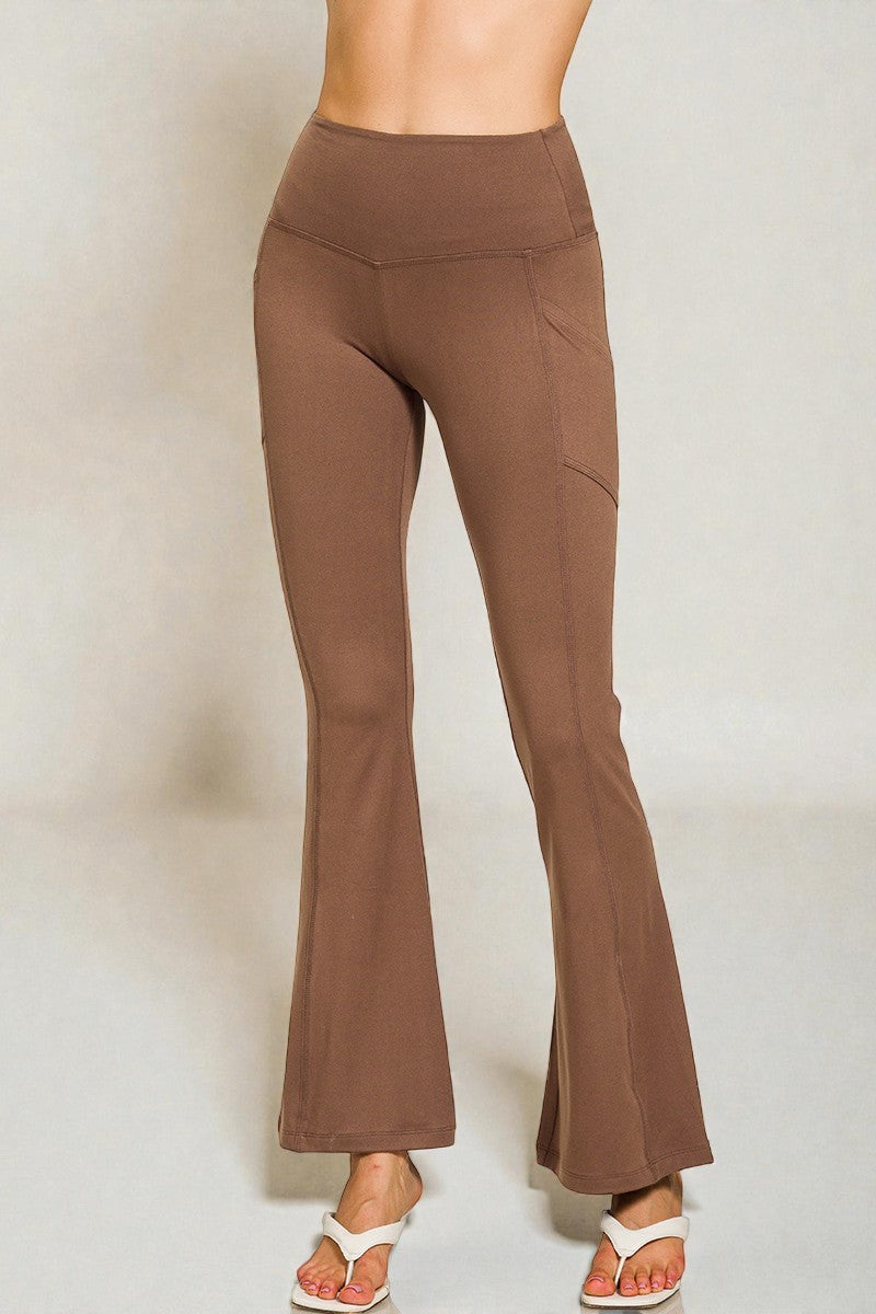 Brown flared pants worn by a person on a plain background