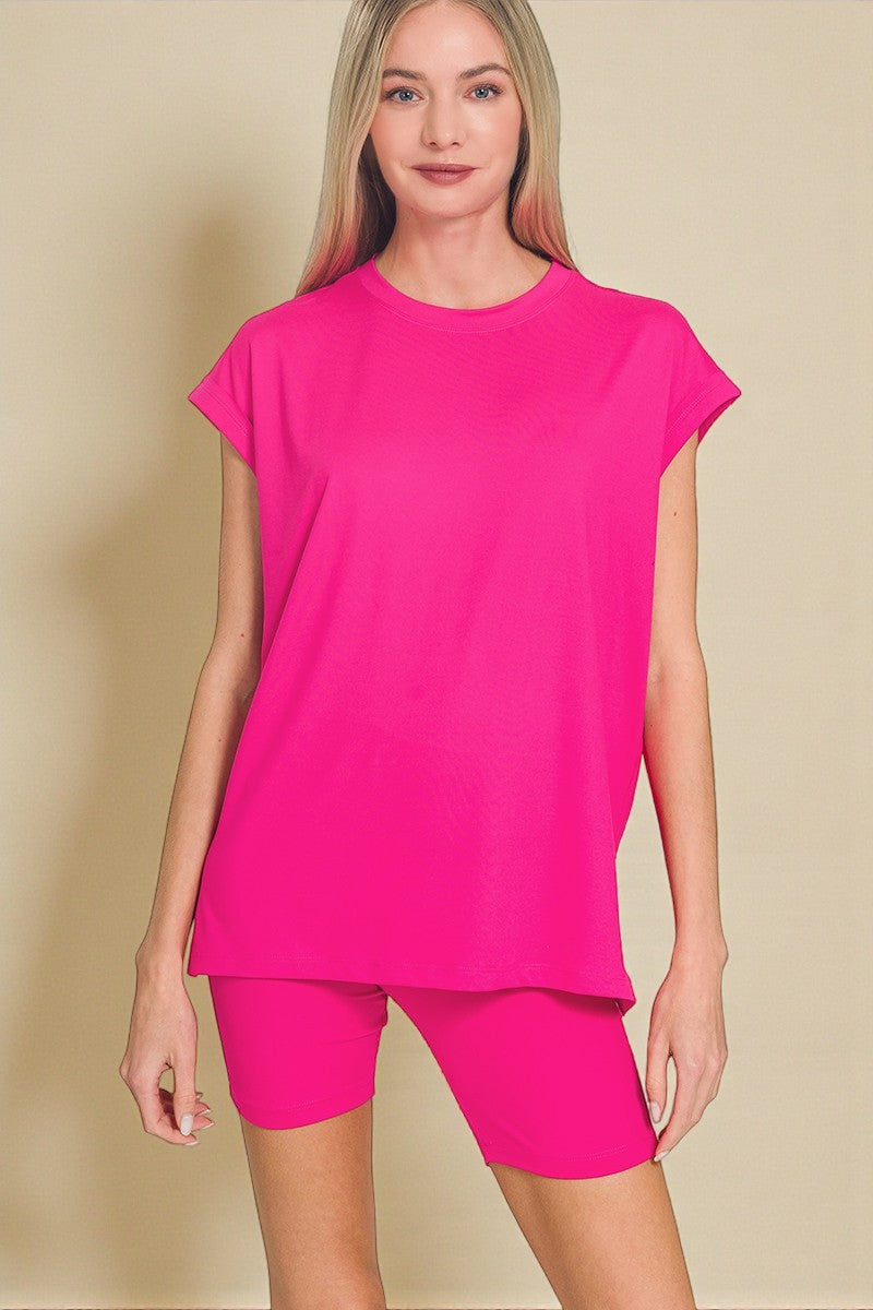 Woman wearing a bright pink outfit on a beige background