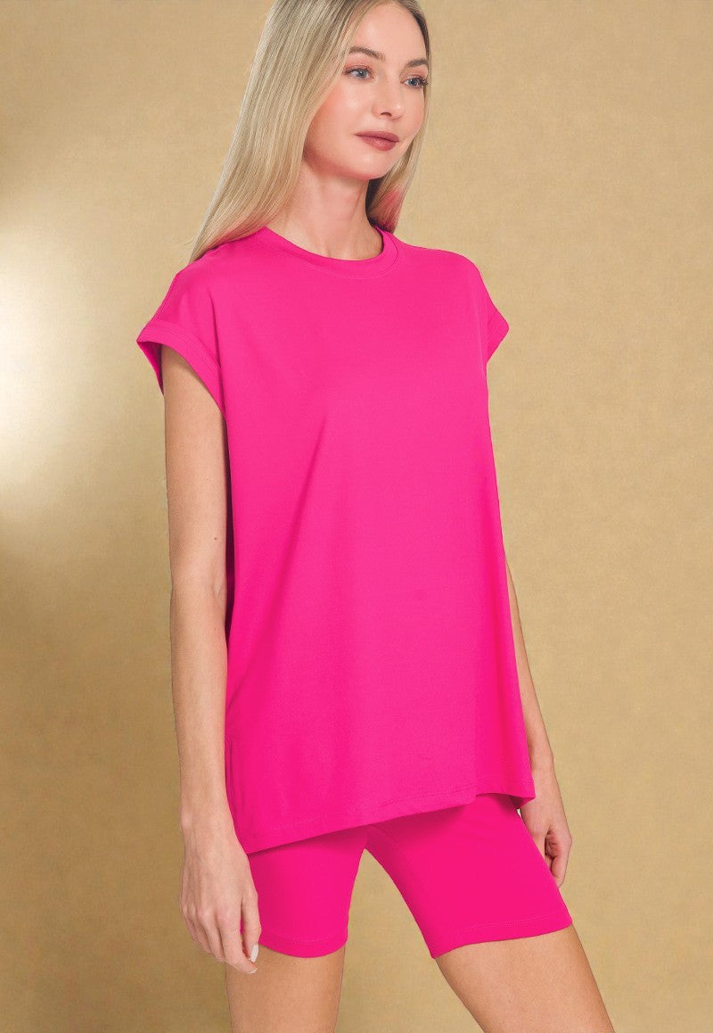 Woman wearing a bright pink outfit on a gold background