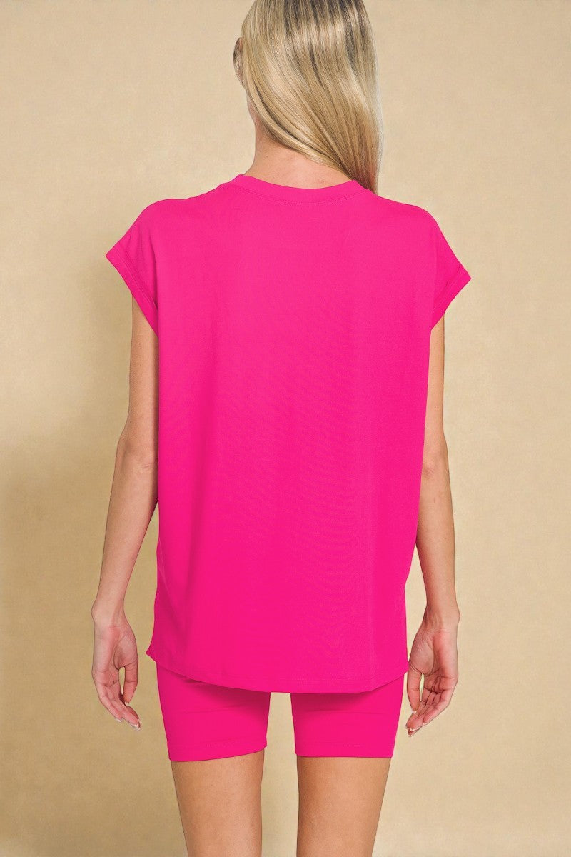 Person wearing a bright pink outfit on a beige background