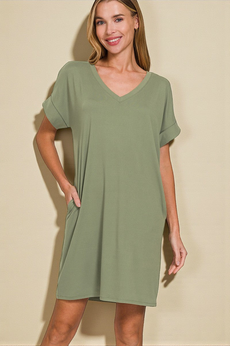 Woman wearing a green dress against a beige background