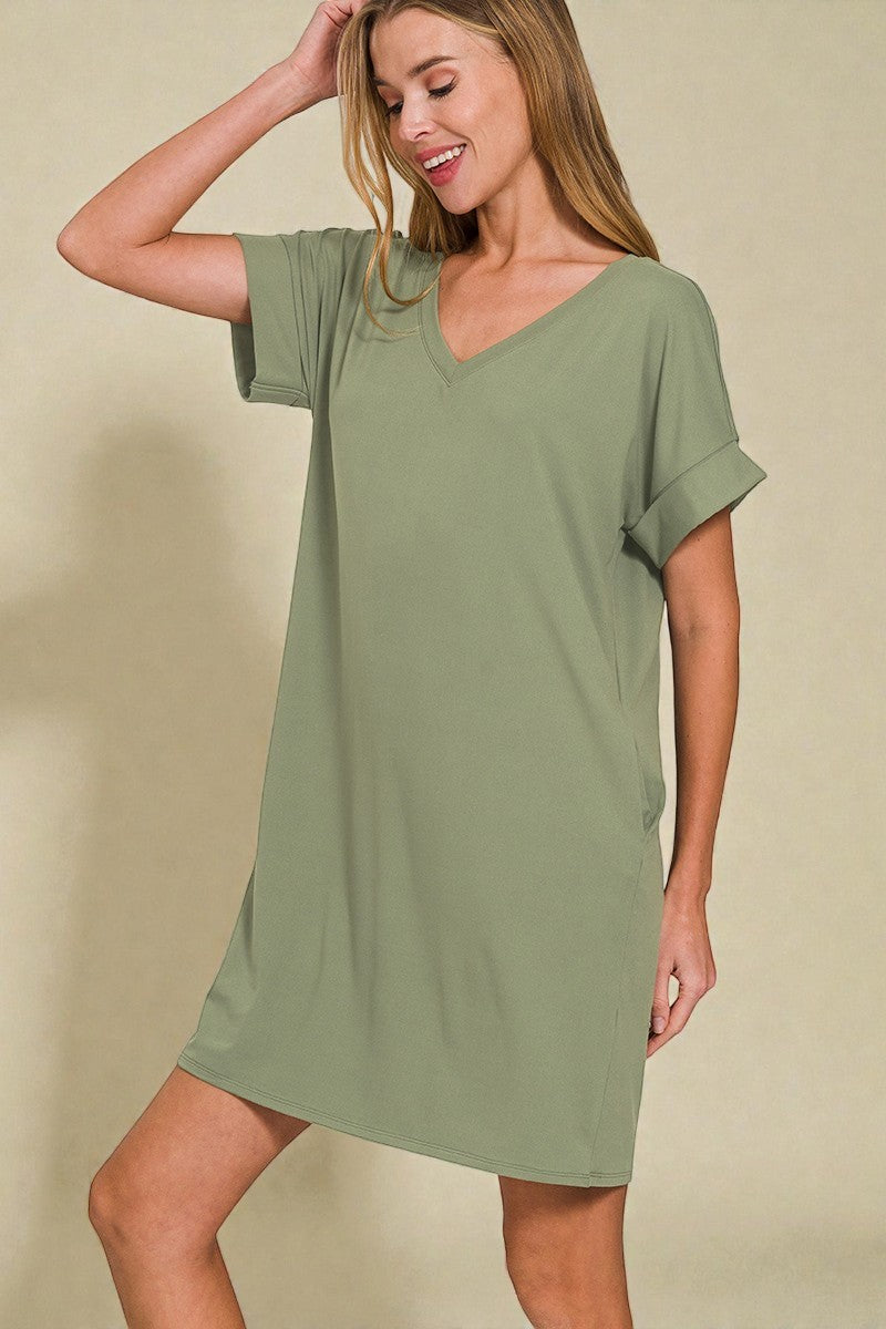 Woman wearing a green dress against a beige background