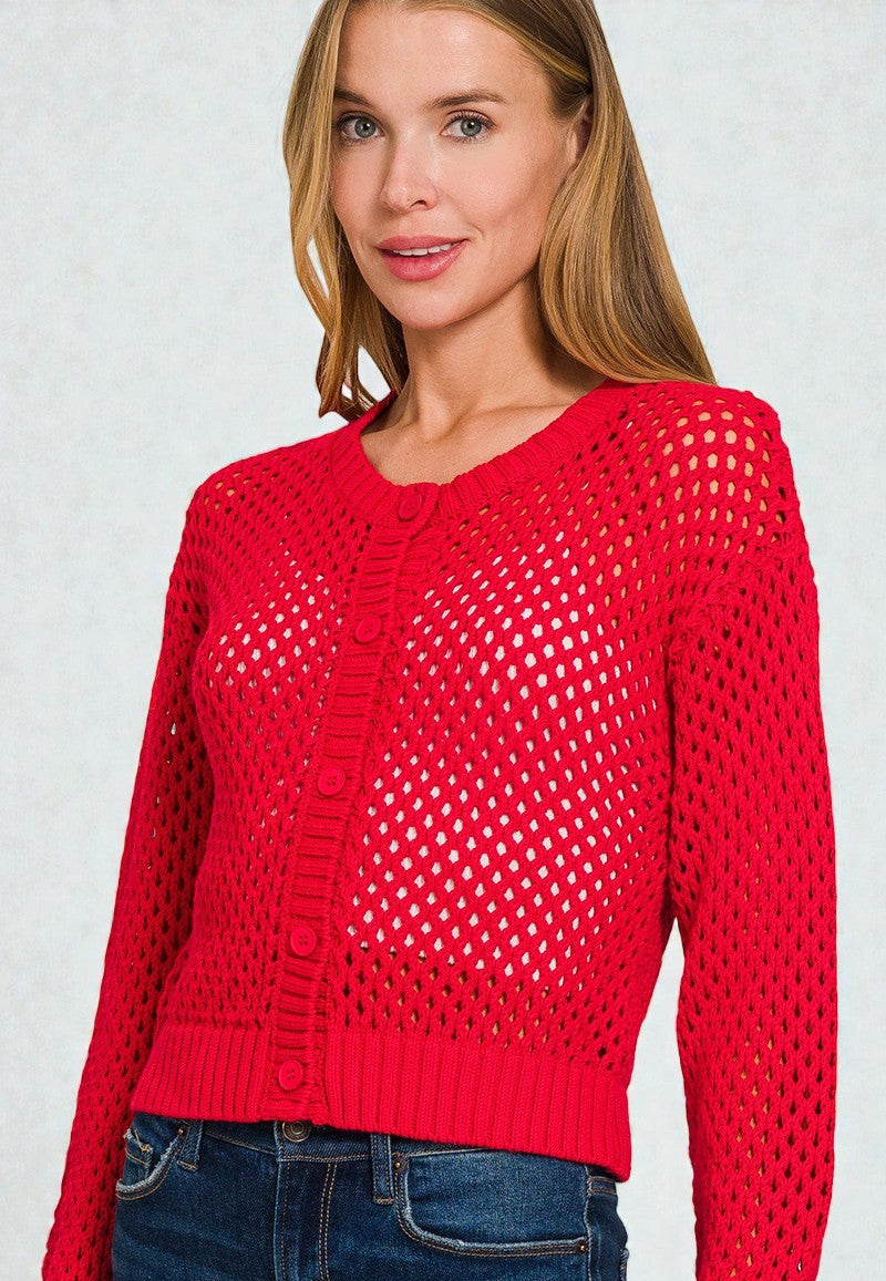 Woman wearing a red open-knit sweater against a light gray background