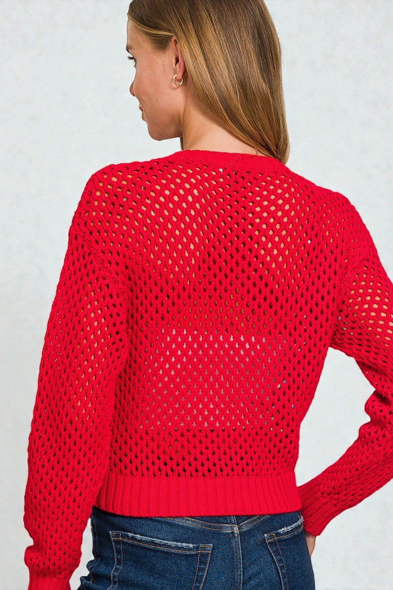 Red open-knit sweater worn by a person on a light gray background