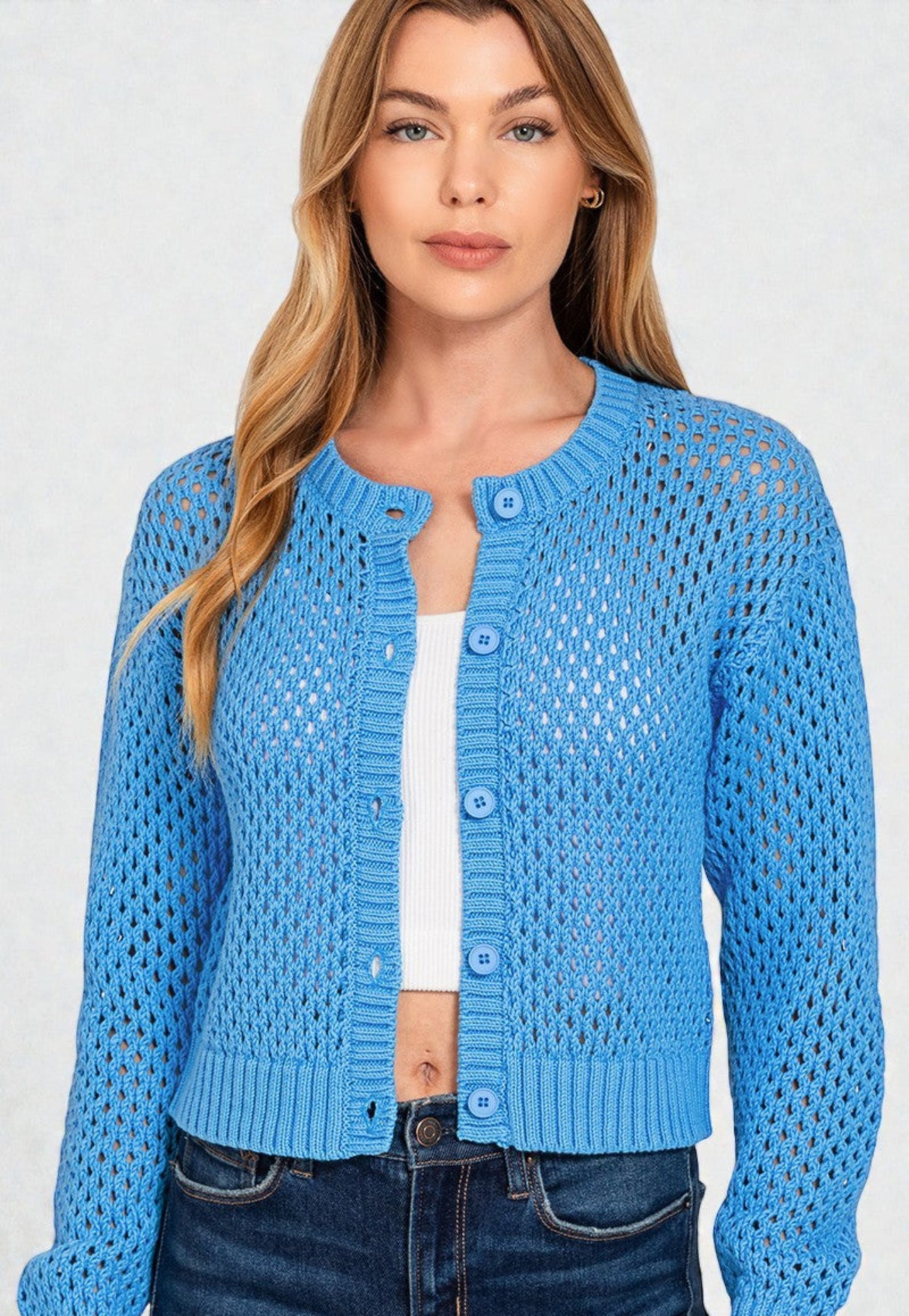 Woman wearing a blue knitted cardigan on a white background