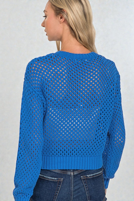 Blue open-knit sweater worn by a person on a plain background